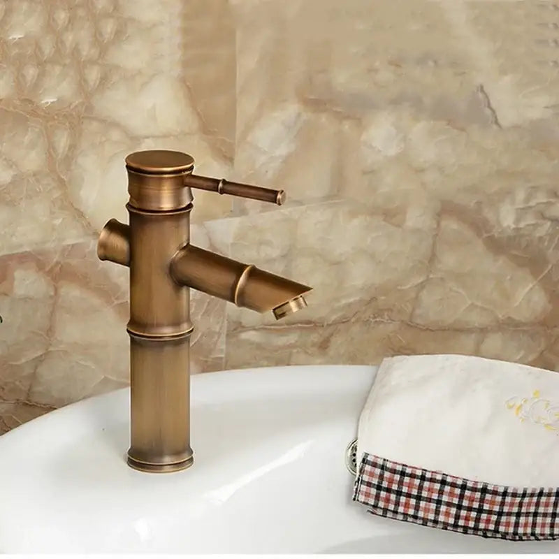 DecorBites antique brass bamboo basin faucet single handle in antique brass for hot and cold water use