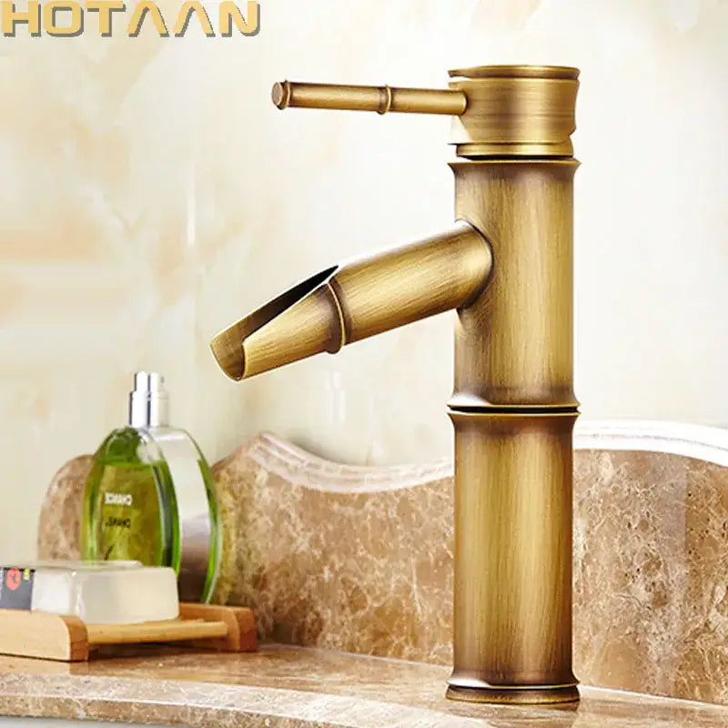 DecorBites antique brass single handle basin faucet in antique brass with bamboo-style segmented design and vintage finish