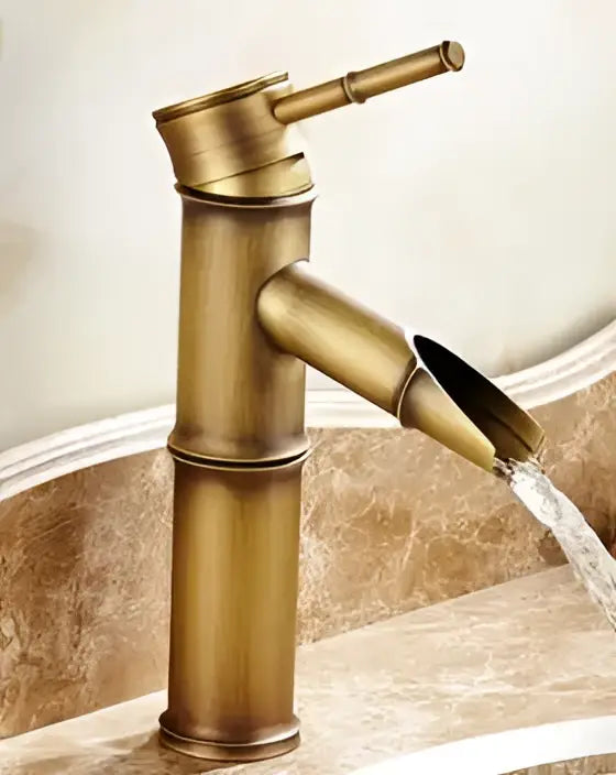 Decorbites antique brass single handle bamboo style basin faucet with waterfall spout in antique brass finish
