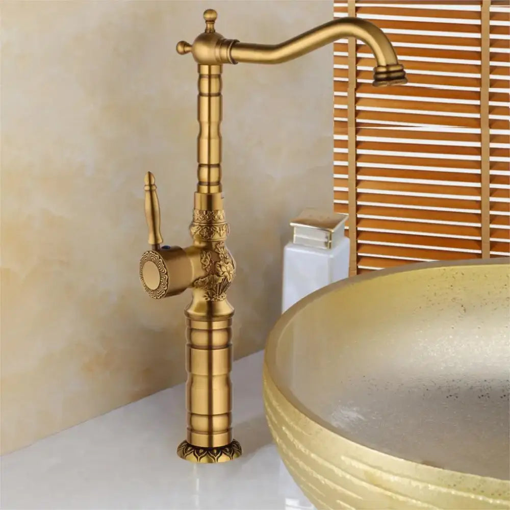 Decorbites antique brass basin faucet with ornate floral detailing and curved spout for bathroom use