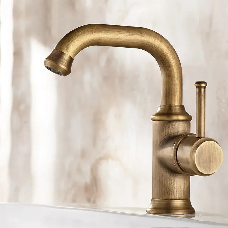 DecorBites antique brass basin faucet with single lever handle and curved spout in brushed metal finish for bathroom sink
