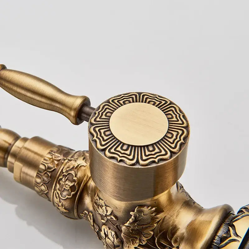 Decorbites antique brass basin faucet with intricate floral and geometric embossing and 360 rotation long spout