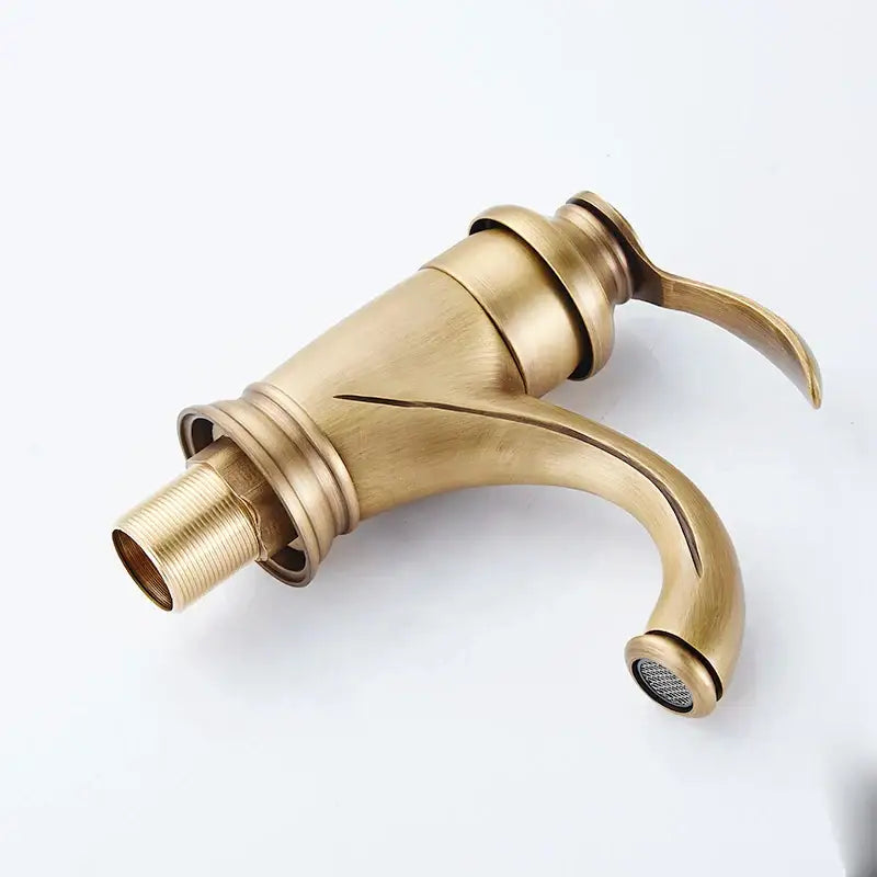DecorBites antique brass basin faucet single handle deck mounted with curved spout and ridged decorative base for bathroom sink