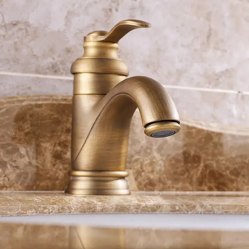Decorbites antique brass basin faucet with single handle curved spout and ridged base for bathroom sink mixer