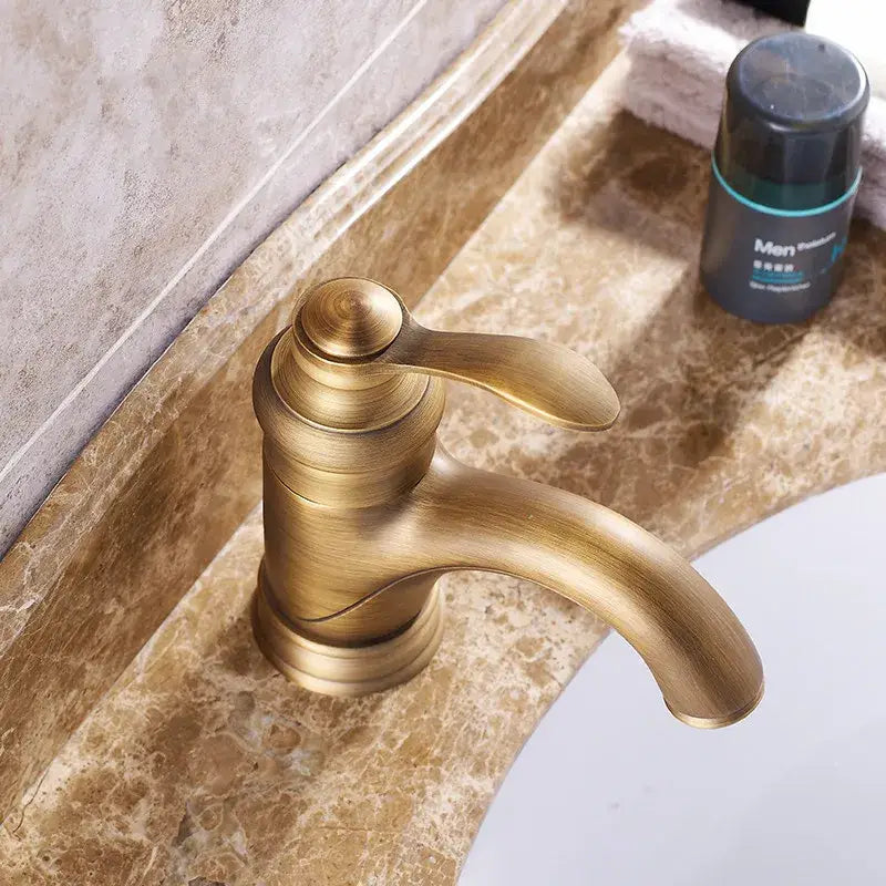 DecorBites antique brass basin faucet single handle deck mounted with sleek curved spout and rounded handle