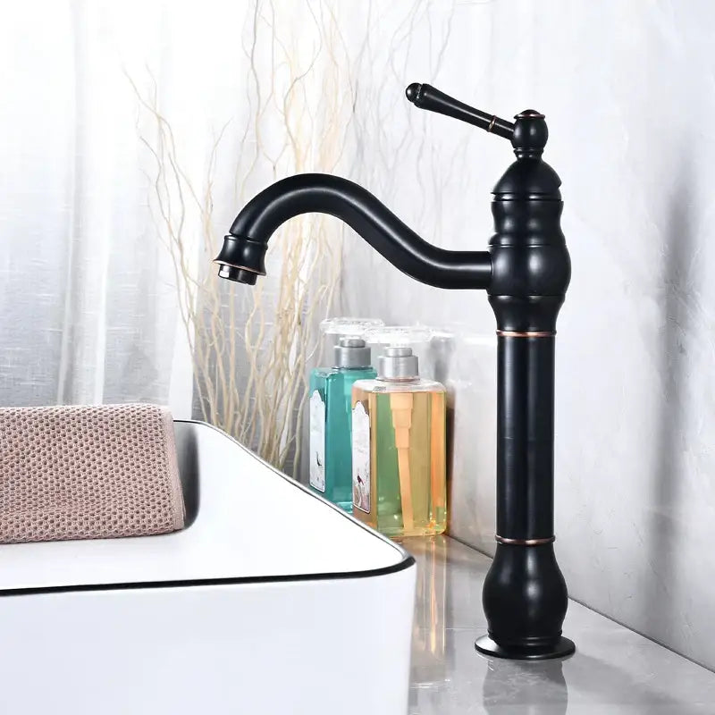 Black matte basin faucet with elegant curved spout and ornate detailing from decorbites antique brass collection