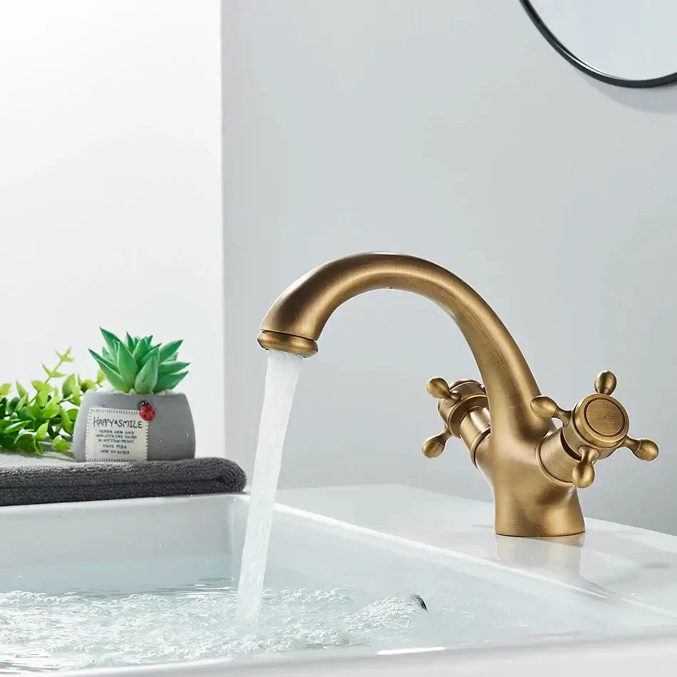 Decorbites antique brass basin faucet with solid brass curved spout and dual cross-handle controls for single hole deck mounting