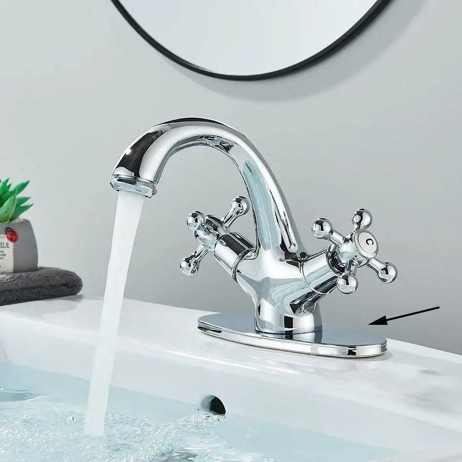Chrome finished two-handle basin faucet with curved spout and cross handles complements antique brass basin faucet design