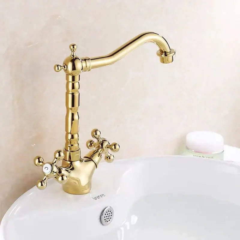 Decorbites antique brass basin faucet with swivel spout and gold-colored cross handles in ornate design