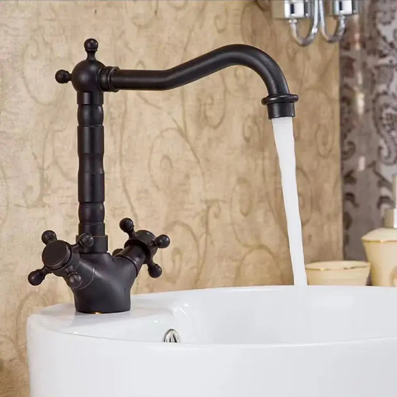 Black matte decorbites antique brass basin faucet with swivel spout and ornate cross handles in vintage style