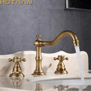 DecorBites antique brass basin mixer tap with three handles, curved spout, and cross-shaped dual handles deck mounted