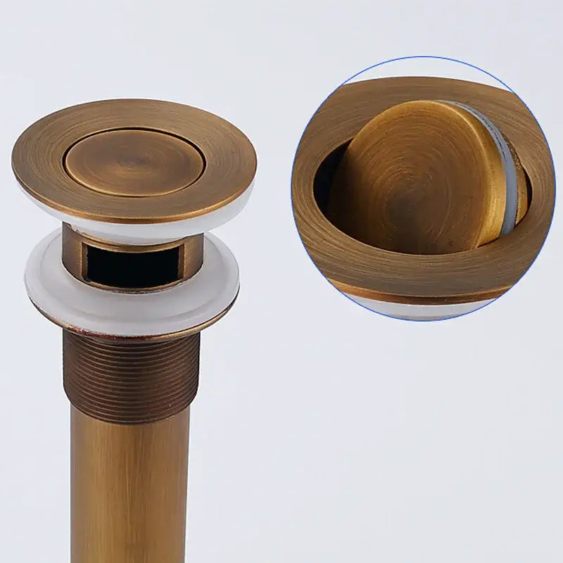 Decorbites antique brass basin sink drain with round push-button, white ceramic base, and threaded metal stem