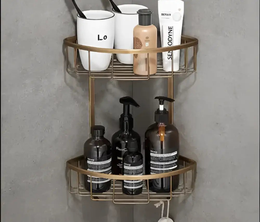 Gold-toned two-tier corner shower caddy with wire mesh shelves from decorbites antique brass bathroom accessory set