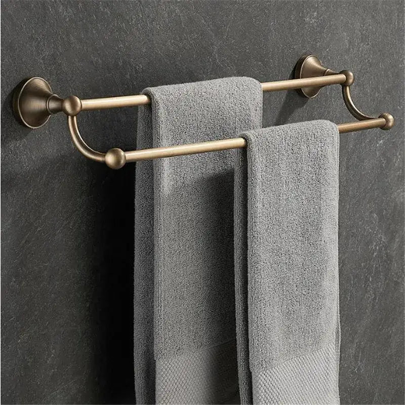 Brass double towel rack with two gray textured towels from DecorBites antique brass bathroom accessory set