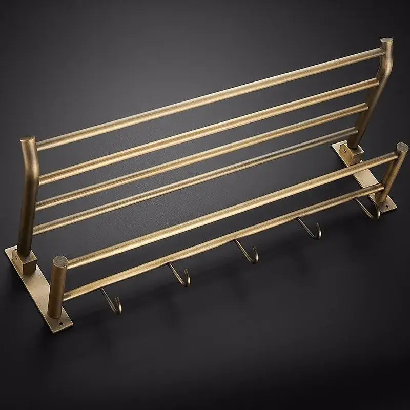 Brass-finished metal towel rack with four bars and integrated hooks from decorbites antique brass bathroom accessory set
