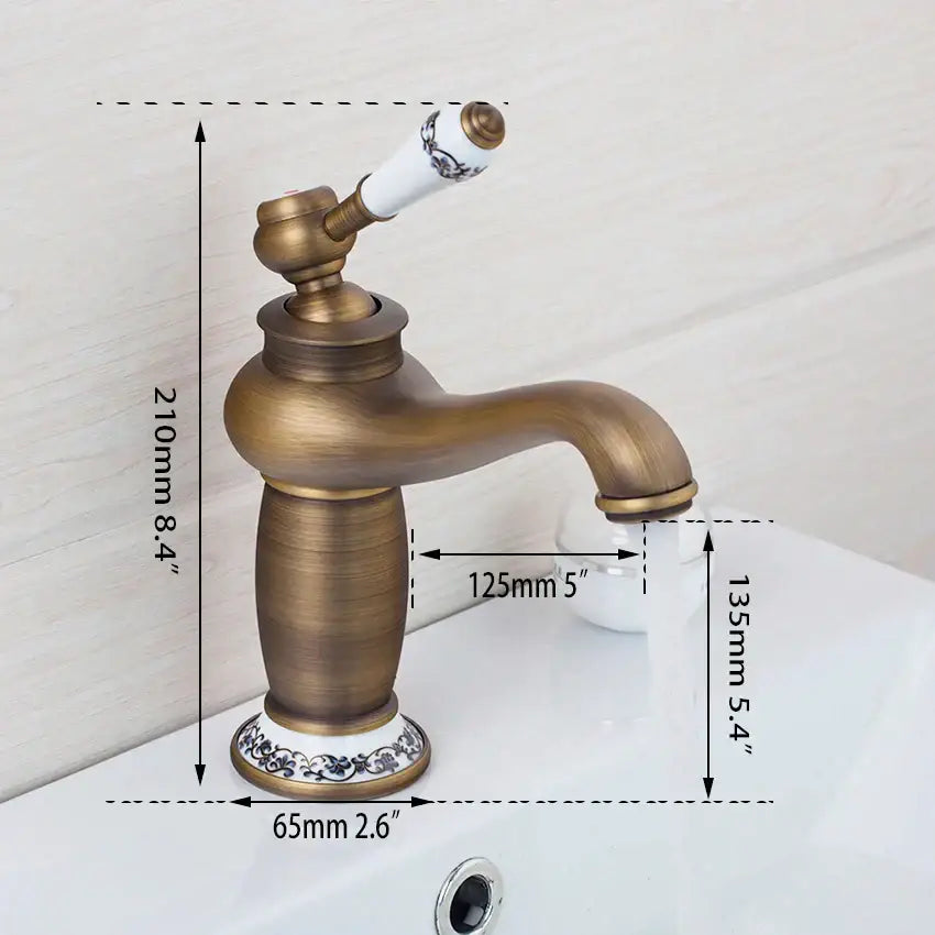 Antique brass bathroom basin faucet by decorbites with white ceramic handle and black floral decorative base
