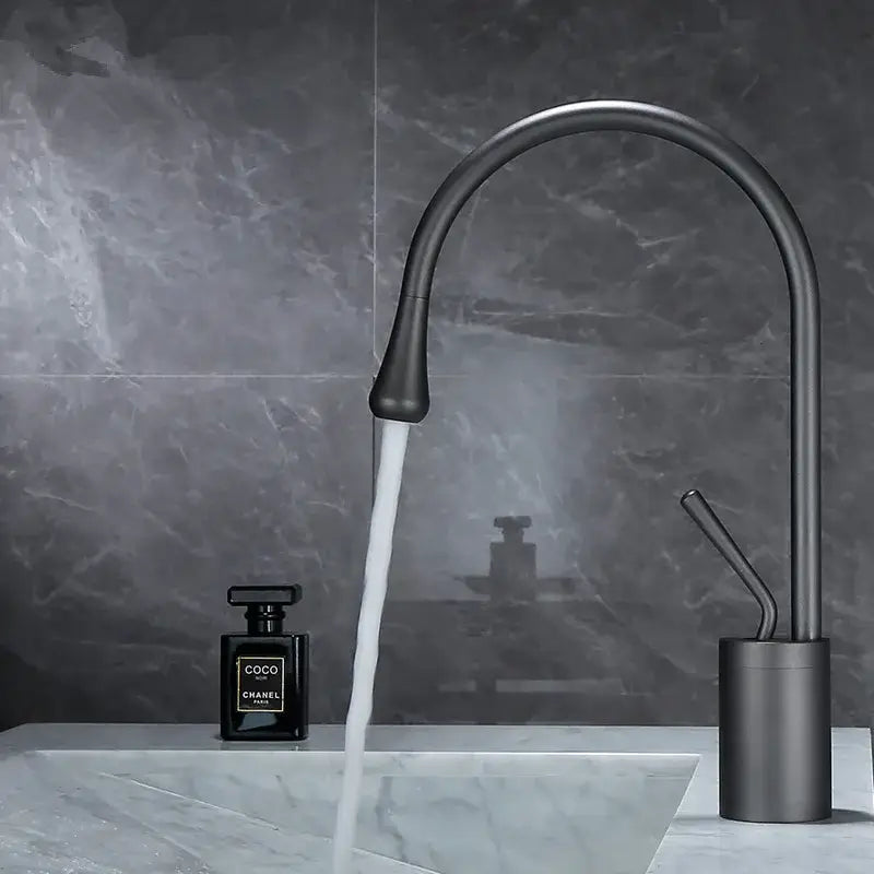 Modern matte black basin faucet with sleek curved spout and cylindrical base for antique brass bathroom basin use