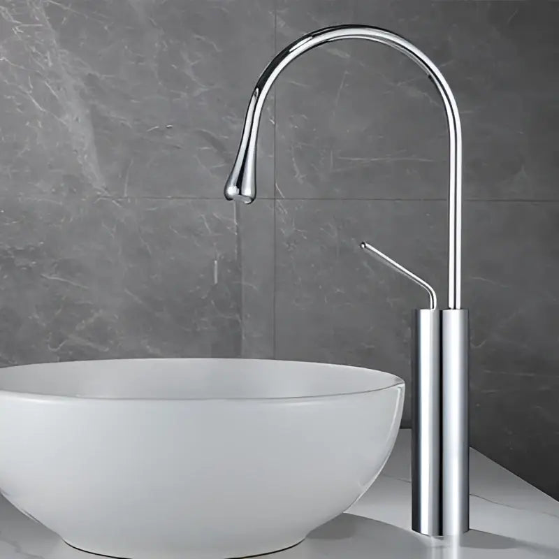 Modern chrome-finished basin faucet with sleek curved spout and minimalist design for antique brass bathroom use