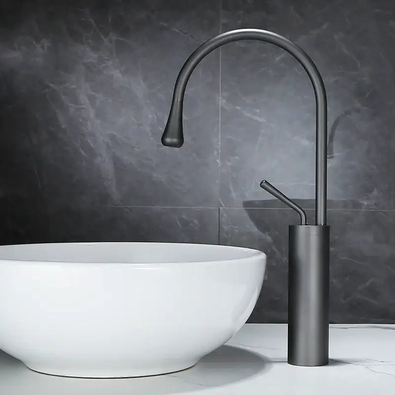 Decorbites™ antique brass bathroom basin faucet with modern matte black finish, sleek curved spout, and cylindrical base