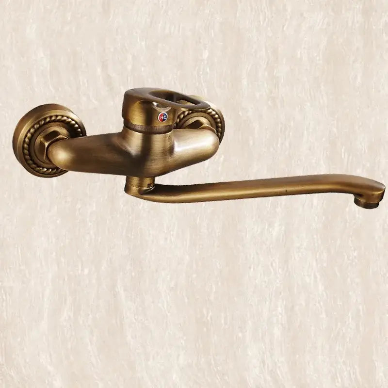 Decorbites antique brass bathroom basin faucet with ornate twisted detailing and curved long spout wall mount