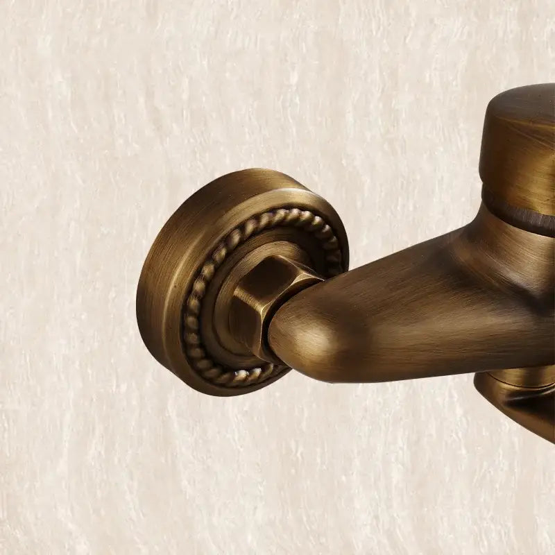 DecorBites™ antique brass bathroom basin faucet wall mount with long spout and decorative rope-like border