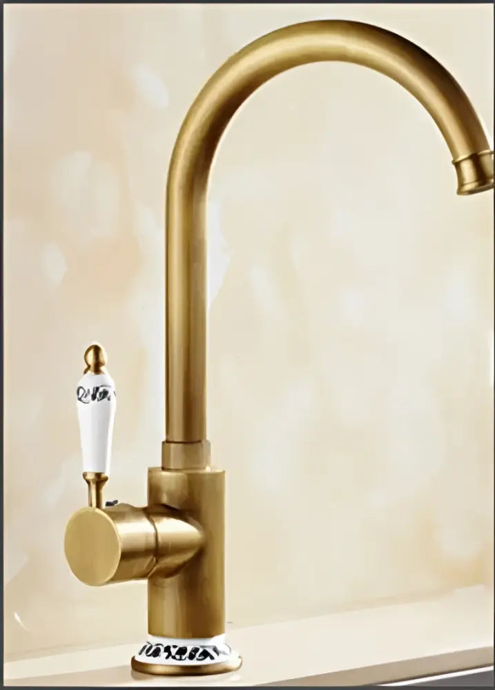 Decorbites™ antique brass bathroom faucet set featuring a curved spout and white ceramic handle with blue floral detailing
