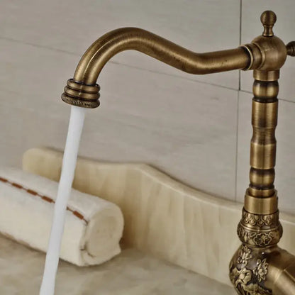 Decorbites™ antique brass bathroom sink faucet mixer with ornate floral detailing and curved spout for hot cold water