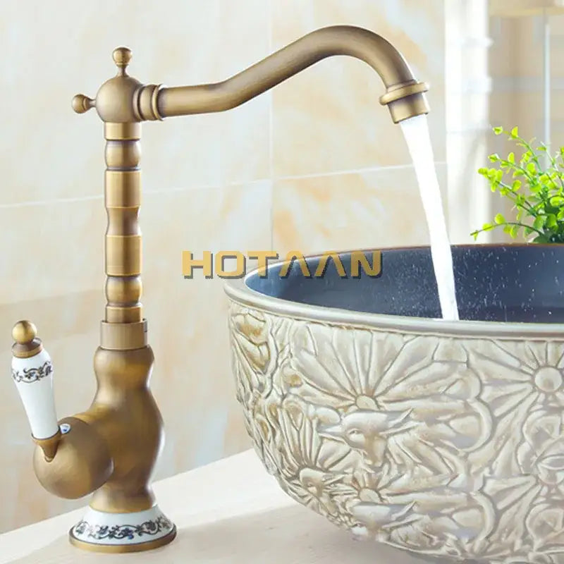Decorbites antique brass bathroom sink faucet with ornate vintage design and white ceramic handle with blue floral detailing
