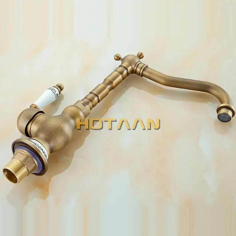 Decorbites antique brass bathroom sink faucet with curved spout and cross-handle controls in brass bathroom sink design