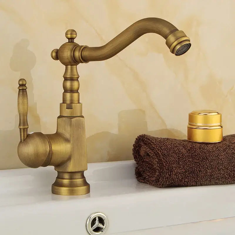 DecorBites antique brass bathroom sink faucet with ornate detailing swivel spout and single handle mixer tap