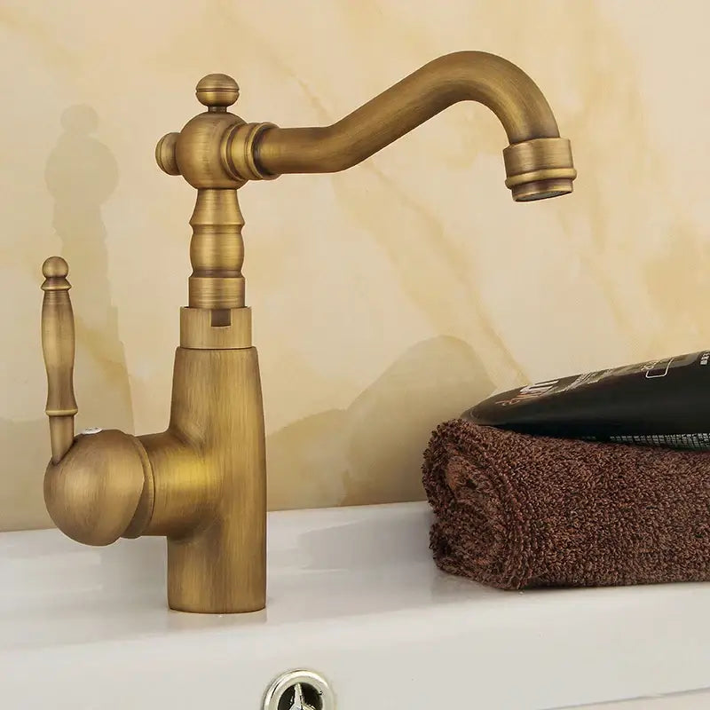 DecorBites antique brass bathroom sink faucet with vintage brass finish swivel spout and single handle mixer tap