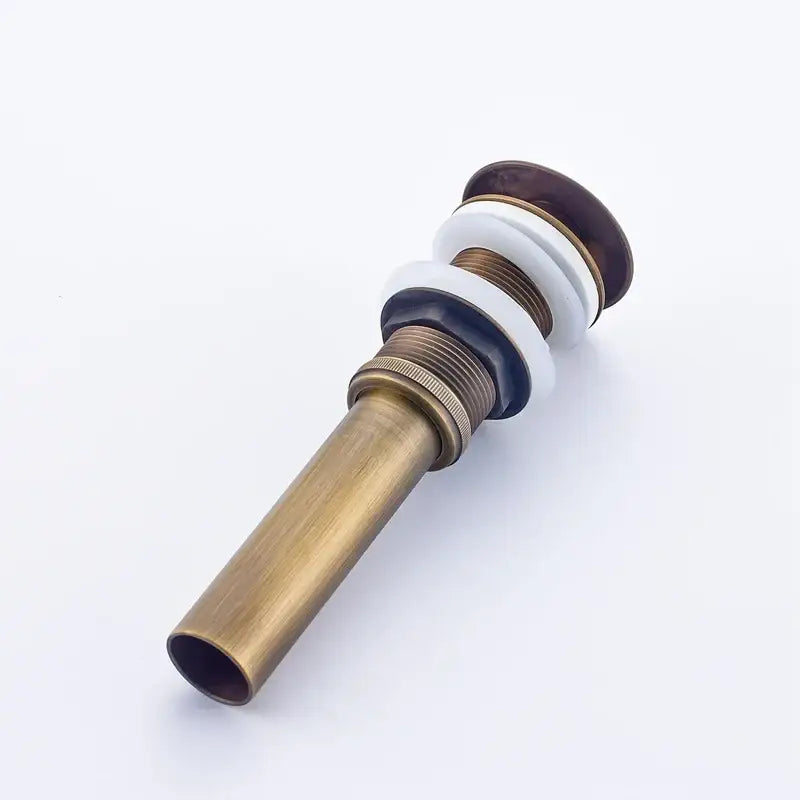 Decorbites antique brass bathroom sink pop up drain stopper with a brass finish and sleek circular top