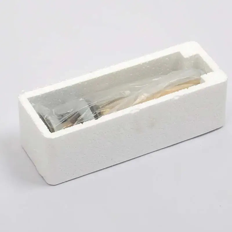 White foam packaging containing metallic utensils wrapped in plastic for decorbites antique brass bathroom sink drain