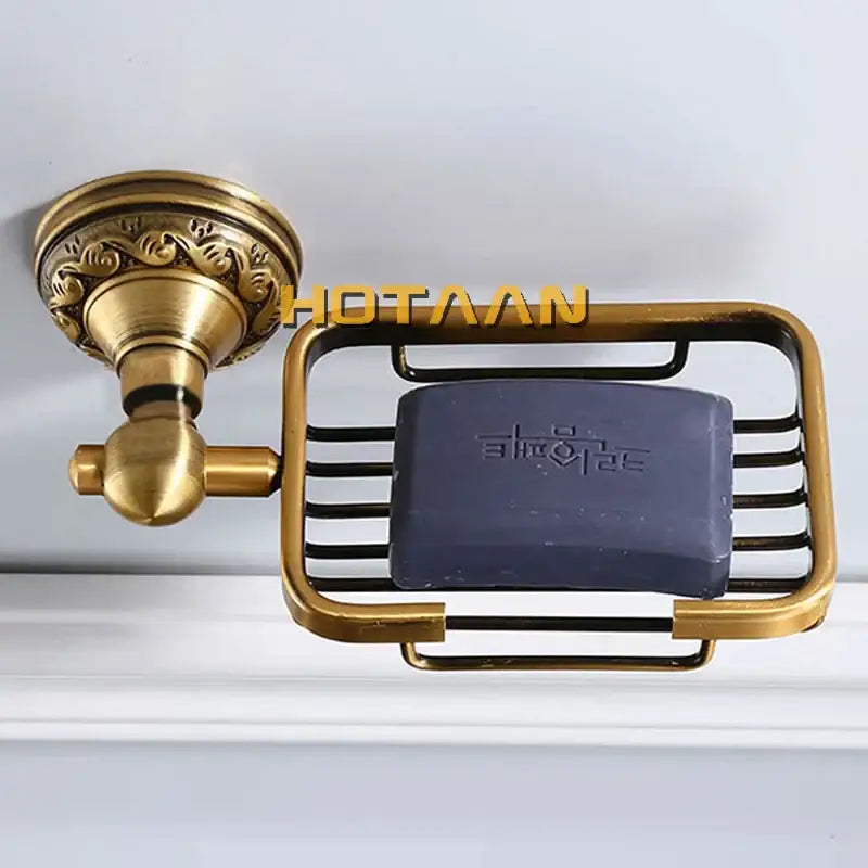 Decorbites™ antique brass bathroom soap dish holder with ornate base and wire mesh basket holding dark blue soap bar