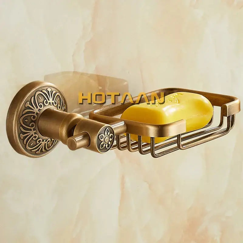Decorbites™ antique brass wall-mounted soap dish holder with ornate floral detailing and wire mesh soap basket holding yellow soap