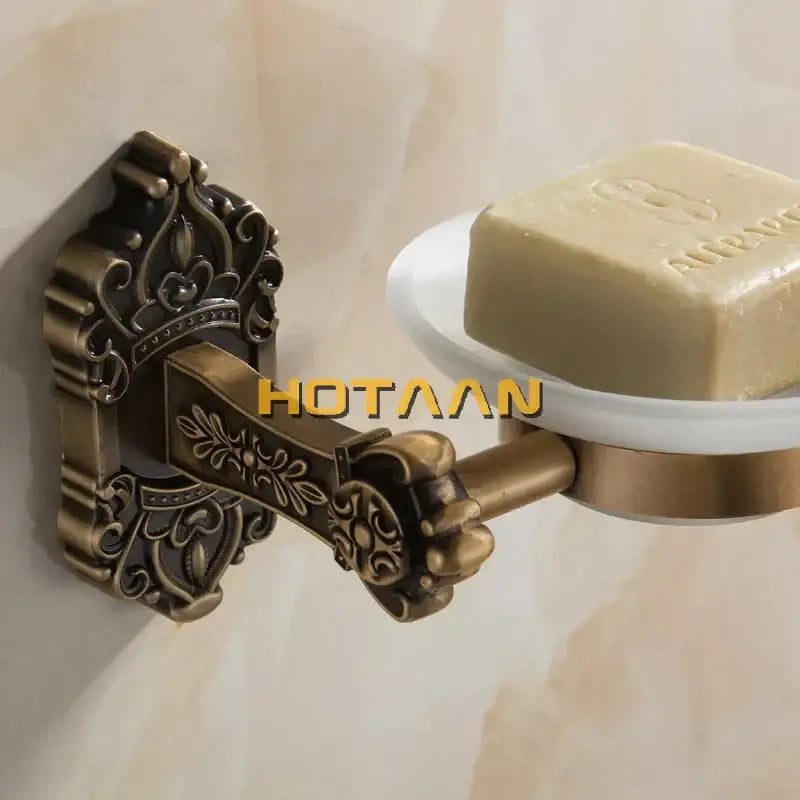 Decorbites antique brass bathroom soap dish with ornate wall-mounted aluminum frame and white ceramic tray holding soap