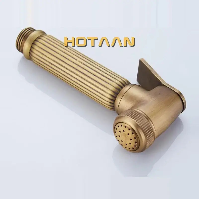 Brass bidet faucet with ribbed handheld showerhead and textured nozzle in antique brass for hygienic use