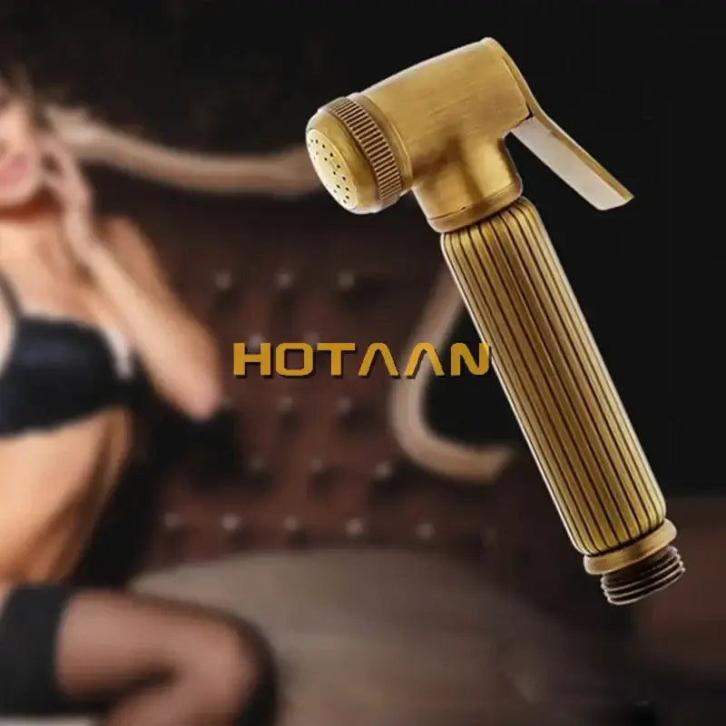 Brass-colored ribbed handheld shower nozzle with textured trigger and perforated spray head for antique brass bidet faucet