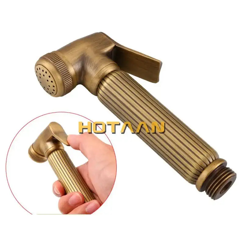 Antique brass bidet faucet handheld shower nozzle with ribbed handle and perforated spray head for hygienic use