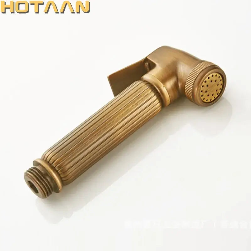 Antique brass bidet faucet handheld shower nozzle with ribbed handle and perforated spray head for hygienic use