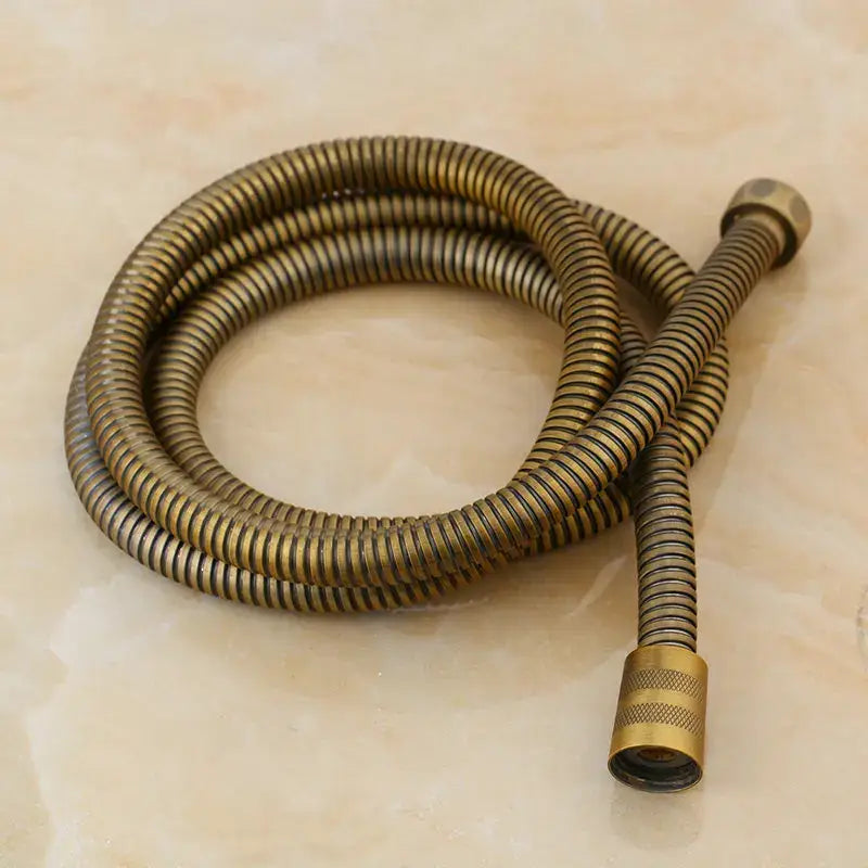Antique brass bidet faucet wall mount with flexible brass spiral hose and textured ends for bathroom accessory use