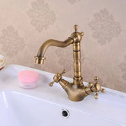 Antique brass double cross handle basin faucet with curved spout and 360 degree swivel for kitchen use