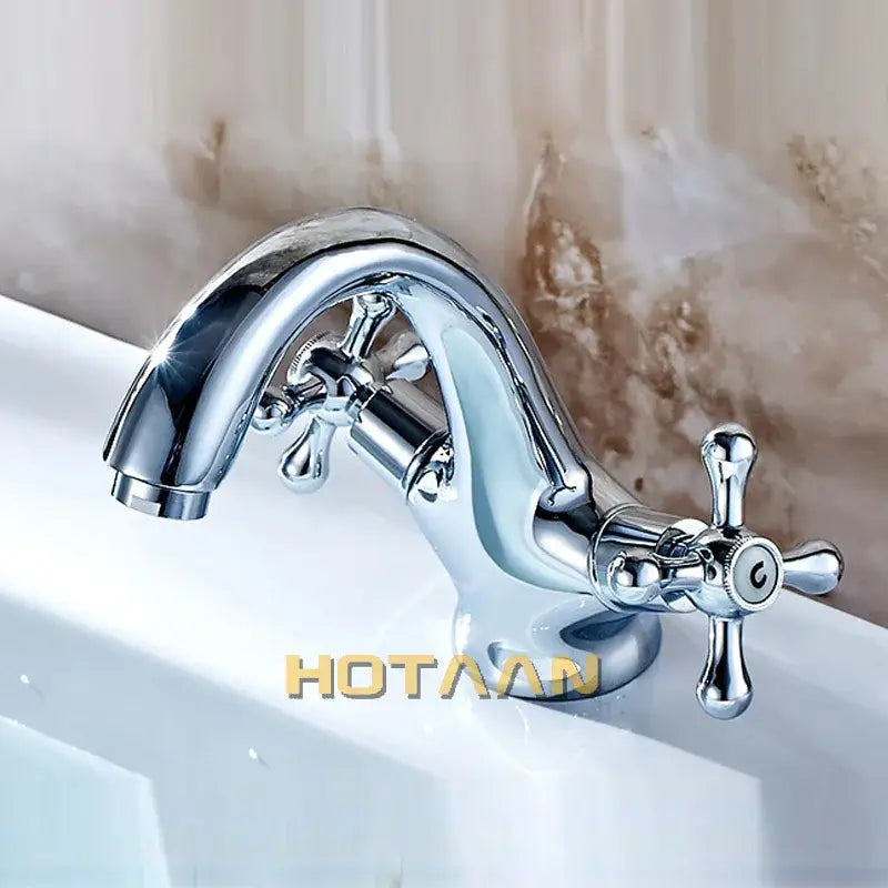 Chrome-finished vintage-style basin mixer tap with cross handles and curved spout for kitchen and bathroom use