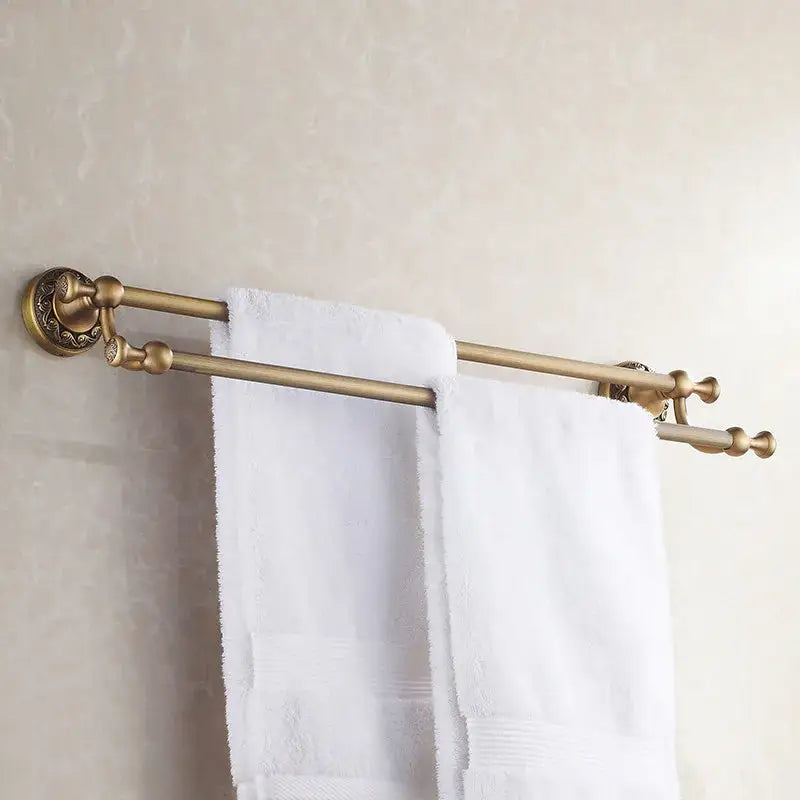 Decorbites antique brass double towel bar with ornate decorative ends and polished finish for bathroom use