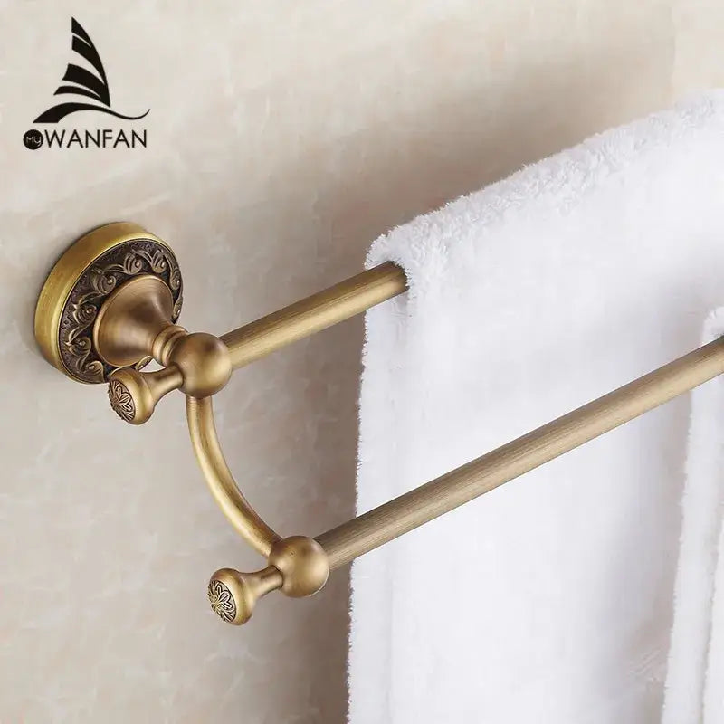 DecorBites antique brass double towel bar with ornate floral detailing on mounting plate and end caps for bathroom use