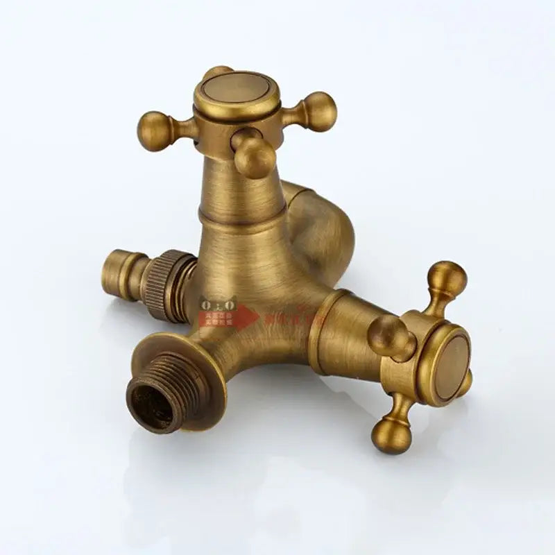 Antique brass three-way outdoor faucet with dual cross handles and threaded connections by decorbites