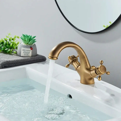 DecorBites antique brass dual handle basin faucet with ornate cross handles and curved spout for bathroom use