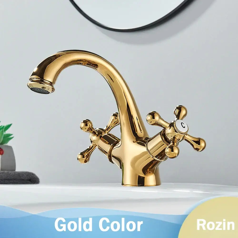 Gold-colored antique brass dual handle basin faucet with cross handles and polished finish for bathroom use