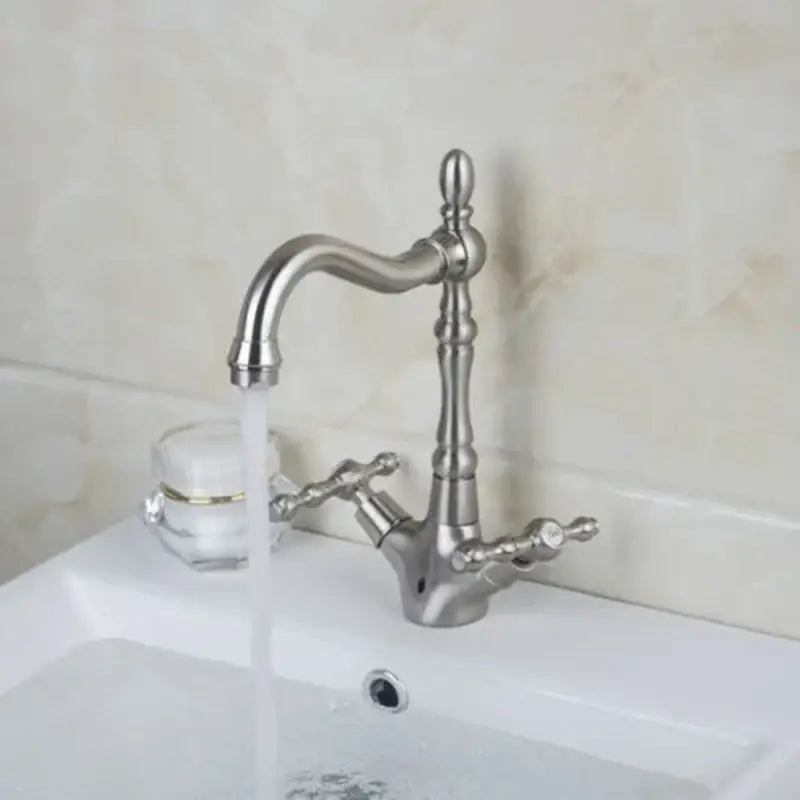 Silver-toned ornate kitchen faucet with curved spout and dual handle knobs for antique brass dual handle design decorbites