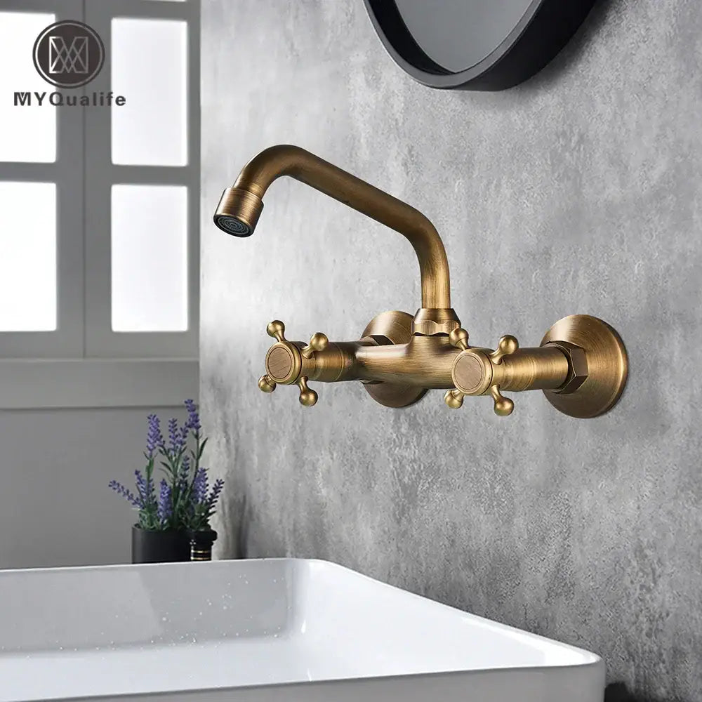 DecorBites™ antique brass dual handle kitchen faucet with ornate cross handles and curved spout wall mounted design